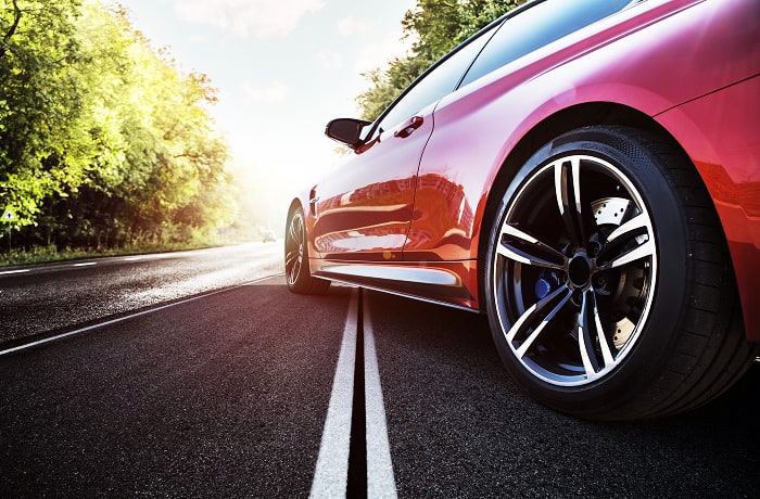 Red sport car on the asphalt road